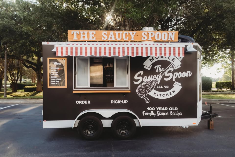 The Saucy Spoon mobile Italian kitchen trailer, order and pick-up windows, parked outdoors